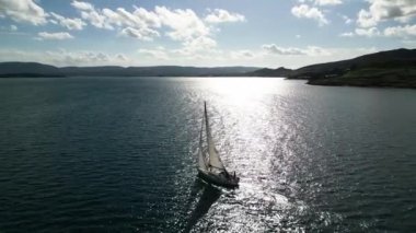 windsurfer sailing in beautiful blue water, top down aerial view. High quality 4k footage