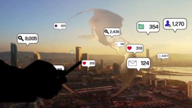 Social media icons fly over city downtown showing people engagement connection through social network application platform . Concept for online community and social media marketing strategy . High