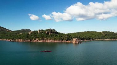 Sport Canoe with a team of four people rowing on tranquil water, Aerial view. High quality 4k footage