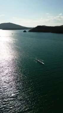 Sport Canoe with a team of four people rowing on tranquil water, Aerial view. High quality 4k footage