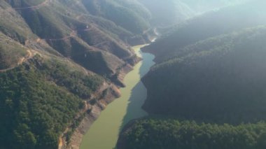 Beautiful landscape in aerial drone shot. Forest woods and calm tranquil lake. . High quality 4k footage