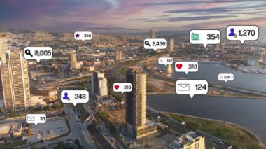 Social media icons fly over city downtown showing people engagement connection through social network application platform . Concept for online community and social media marketing strategy . High