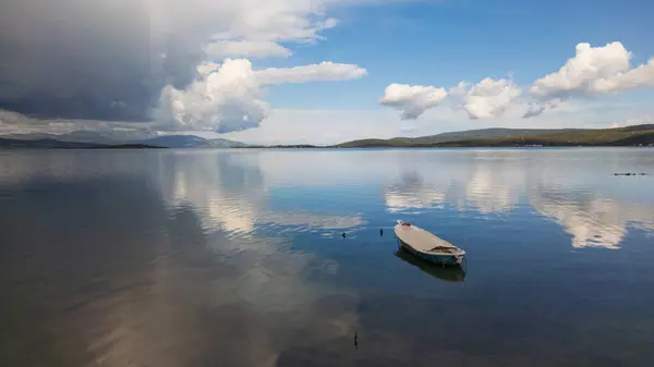 stock image A small boat at beach of Urla, izmir. beautiful clouds