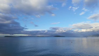 Arkasında dağlar olan büyük bir su kütlesi. Yüksek kalite 4k görüntü