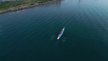 Sport Canoe with a team of four people rowing on tranquil water, Aerial view. High quality 4k footage