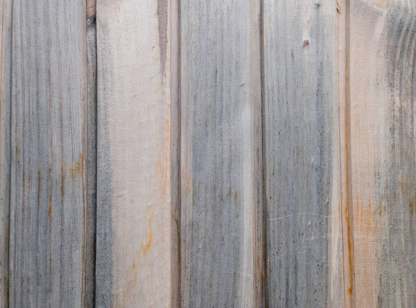 Aged texture of soft gray and orange colors, dotted with horizontal stripes and knots of real wood