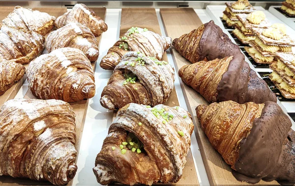 Freshly baked croissants in a bakery surrounded by pastries. First-class chocolate recipes for exquisite palates