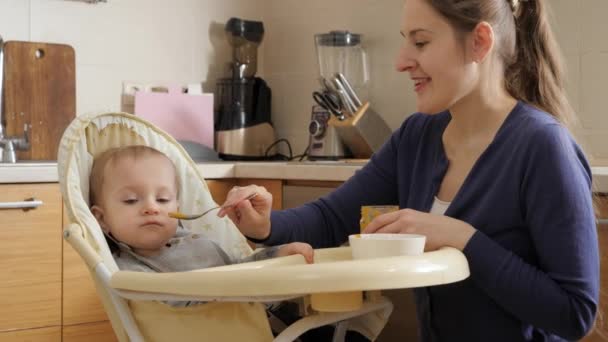 Portrait Smiling Mother Feeding Her Baby Son Porridge Spoon Concept — Stockvideo