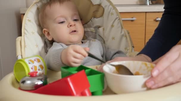 Portrait Mother Wiping Paper Towel Her Messy Baby Boy Eating — Stockvideo