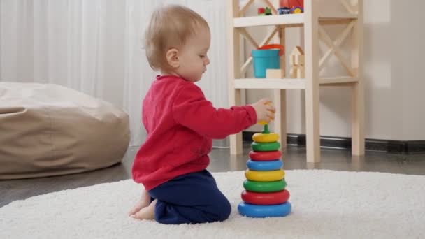 Yaşındaki Küçük Bebek Yerde Oturuyor Renkli Oyuncak Kulesi Inşa Ediyor — Stok video