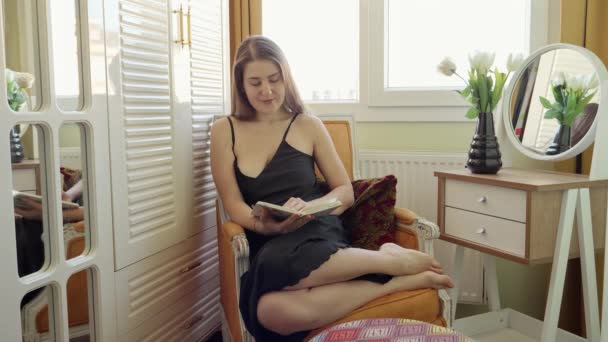 Счастливая Улыбающаяся Женщина Отдыхает Кресле Читает Книгу Развлечения Женщин Образование — стоковое видео