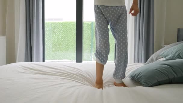 Slow Motion Child Feet Jumping Bid Bed Window Happy Childhood — Stock Video