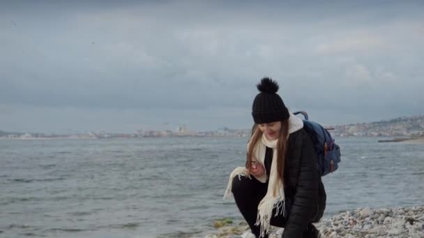 배낭을 해변을 걸어다니며 아름다운 껍질을 여자가 있었다 하이킹 여행의 — 비디오