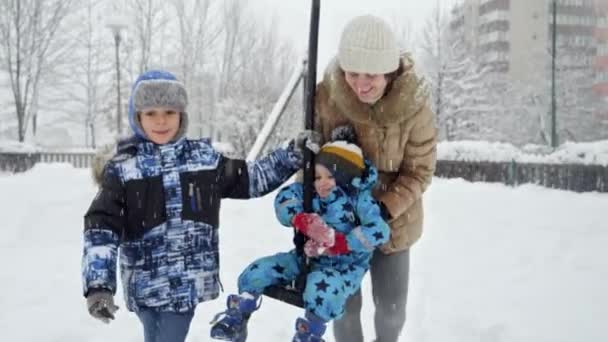 Happy Cheerful Mother Her Two Sons Playing Snow Playground Riding — Stock Video
