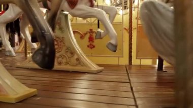 Ahşap atlar ve kızaklar lunaparkta dönen renkli çocukların atlıkarıncalarına yakın çekim.