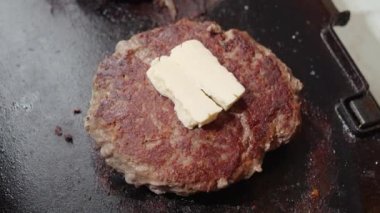 Elektrikli ızgarada sığır eti köftesinde tereyağı erimesi. Evde yemek pişirme, mutfak aletleri, sağlıklı beslenme, hamburger malzemeleri.