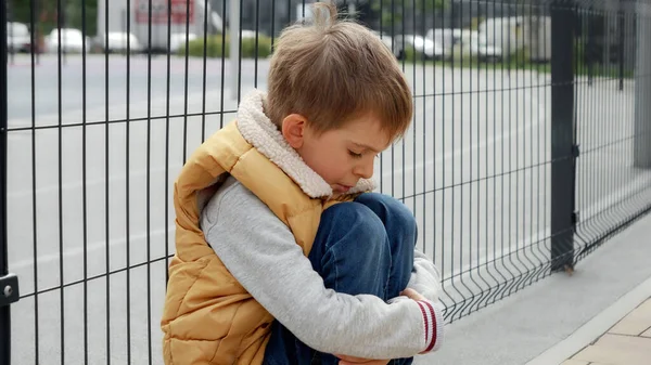 Portrait Little Boy Crying While Sitting Alone Next Metal Fence — Stock Photo, Image
