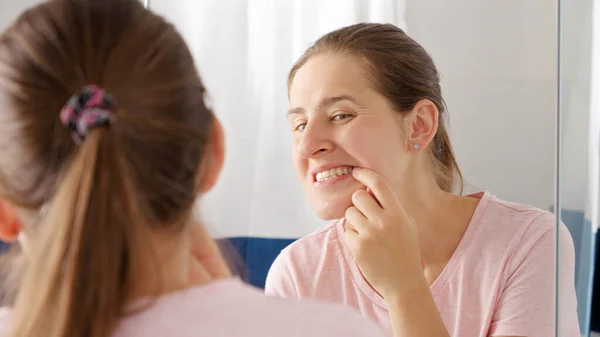 Portrait Smiling Young Woman Opens Mouth Looks Reflection Her Teeth — Stock Photo, Image