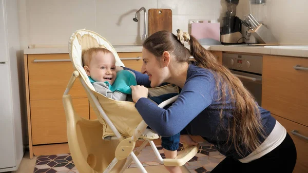 Yong Madre Poniendo Babero Alimentación Hijo Bebé Sentado Trona Cocina — Foto de Stock