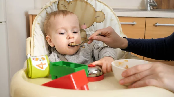 Portrait Little Baby Boy Playing Toys While Mother Feeding Him — Stock Photo, Image