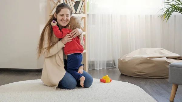 Cheerful Smiling Woman Hugging Her Little Baby Boy While Sitting — Stock Photo, Image