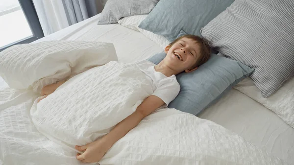 Young Boy Jumps Out His Blanket Laughing Sense Playfulness Merriment — Stock Photo, Image