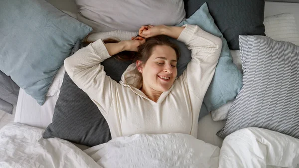 Beaming Young Woman Wakes Bed Stretches Her Arms Lets Out — Stock Photo, Image