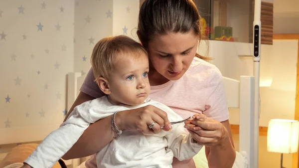 Portrait Young Concentrated Mother Cutting Her Baby Fingernails Parenting Child — Stock Photo, Image