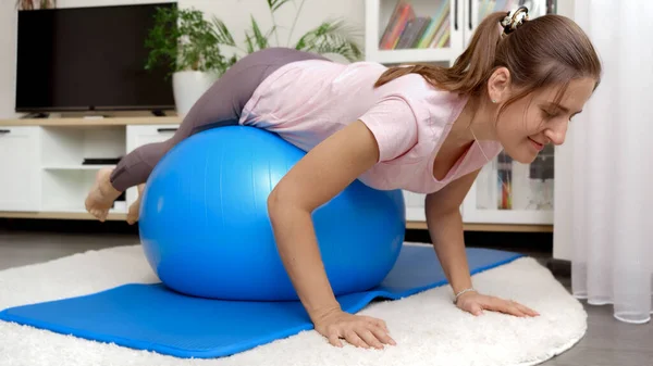 Young Smiling Woman Rolling Balancing Big Blue Ball While Doing — Stock Photo, Image