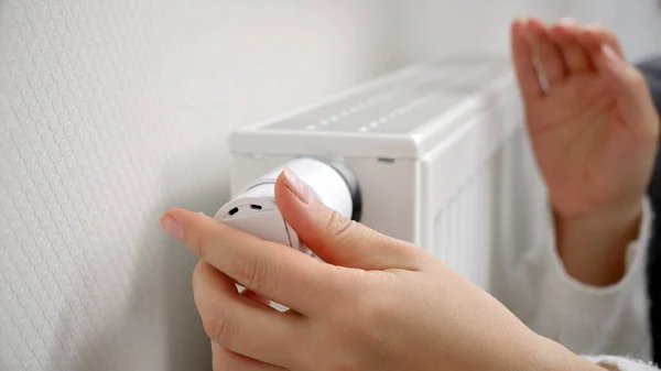 Closeup Woman Adjusting Heating Radiator Valve Warming Hands Concept Energy — Stock Photo, Image