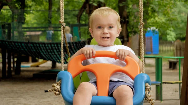 Feliz Niño Sonriente Divirtiéndose Balanceándose Columpio Colorido Parque Niños Jugando — Foto de Stock