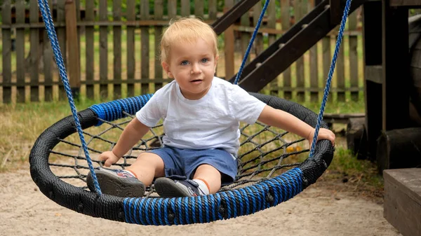 Cute Smiling Toddler Boy Swinging Rope Nest Swing Park — Stock Photo, Image