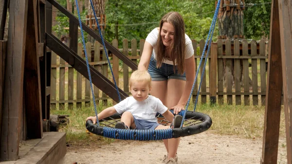Happy Mother Boy Swinging Rope Nest Swing Playground Kids Playing — Stock Photo, Image