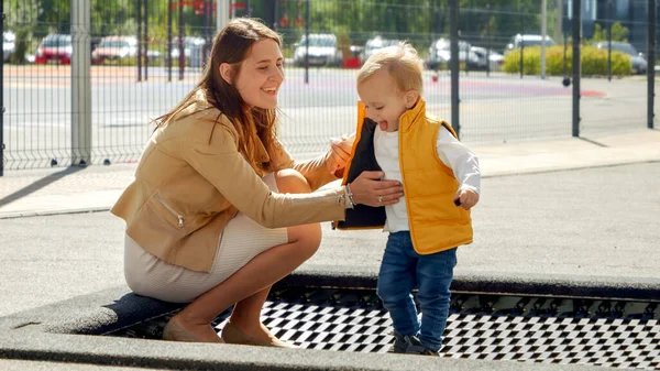 Słodki Chłopiec Trzyma Rękę Matki Podczas Skakania Trampolinie Placu Zabaw — Zdjęcie stockowe