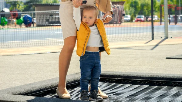 トランポリンで 母親と飛び跳ねる小さな男の子 ハッピーな子育て 家族と一緒に時間を過ごす 子供と親は屋外で — ストック写真