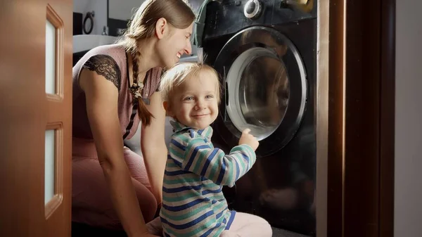 Gelukkige Moeder Met Kleine Jongen Die Doet Naar Wasmachine Kijkt — Stockfoto