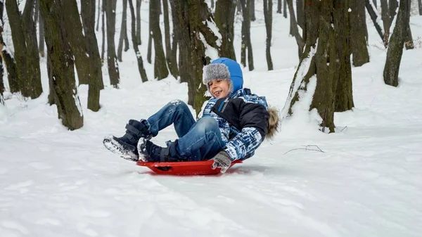 Young Boy Joyfully Sledging Snowy Hill His Plastic Sled Snowy — Stock Photo, Image