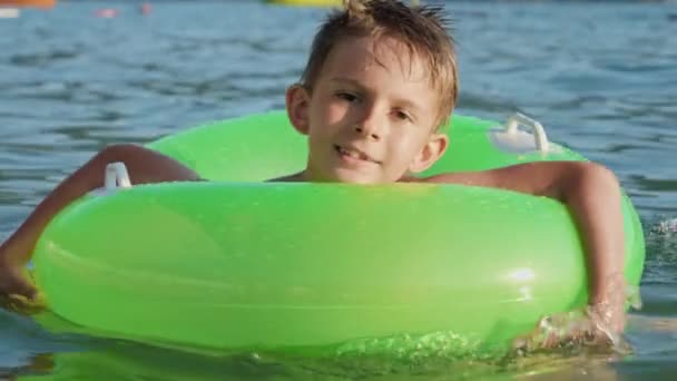 Портрет Милого Улыбающегося Мальчика Плавающего Надувным Кольцом Море Освещенном Закатом — стоковое видео