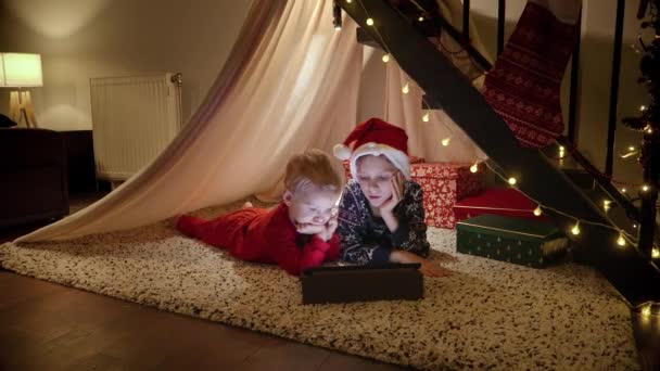 Two Boy Watching Video Tablet Computer While Waiting Christmas New — Stock Video