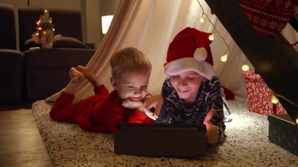 Two Little Boy Having Video Talk Tablet Computer While Lying — Stock Video