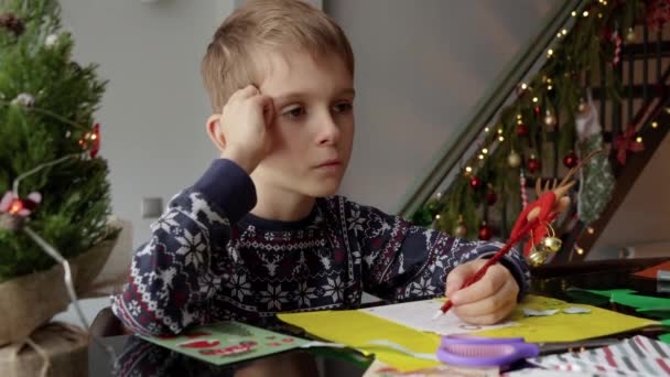 Portrait Thoughtful Little Boy Thinking What Wish Christmas While Writing — Stock Video