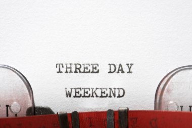 Three day weekend phrase written with a typewriter. clipart