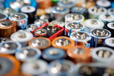 Close up of a large group of used batteries for recycling process clipart