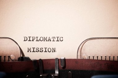 Diplomatic mission text written with a typewriter. clipart