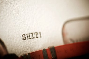 Shit word written with a typewriter.