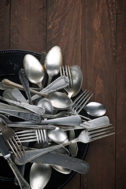 Metal cutlery on a wooden table