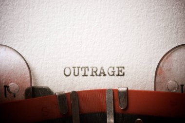 Outrage word written with a typewriter. clipart