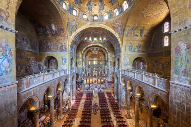 Venice, Italy - August 9, 2025: Tourists visiting the interior of St. Mark's Cathedral.