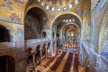 Venice, Italy - August 9, 2025: Tourists visiting the interior of St. Mark's Cathedral.