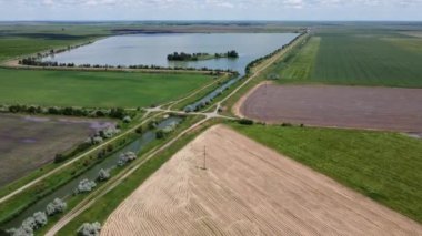 The bridge over the river that flows into the lake with the island. Aerial. High quality FullHD footage